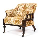 An Edwardian upholstered tub chair in floral fabric on turned front legs and original castors.