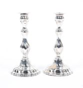 A pair of white metal candlesticks with twist stems and weighted bases, stamped 925. Gross. 336g.