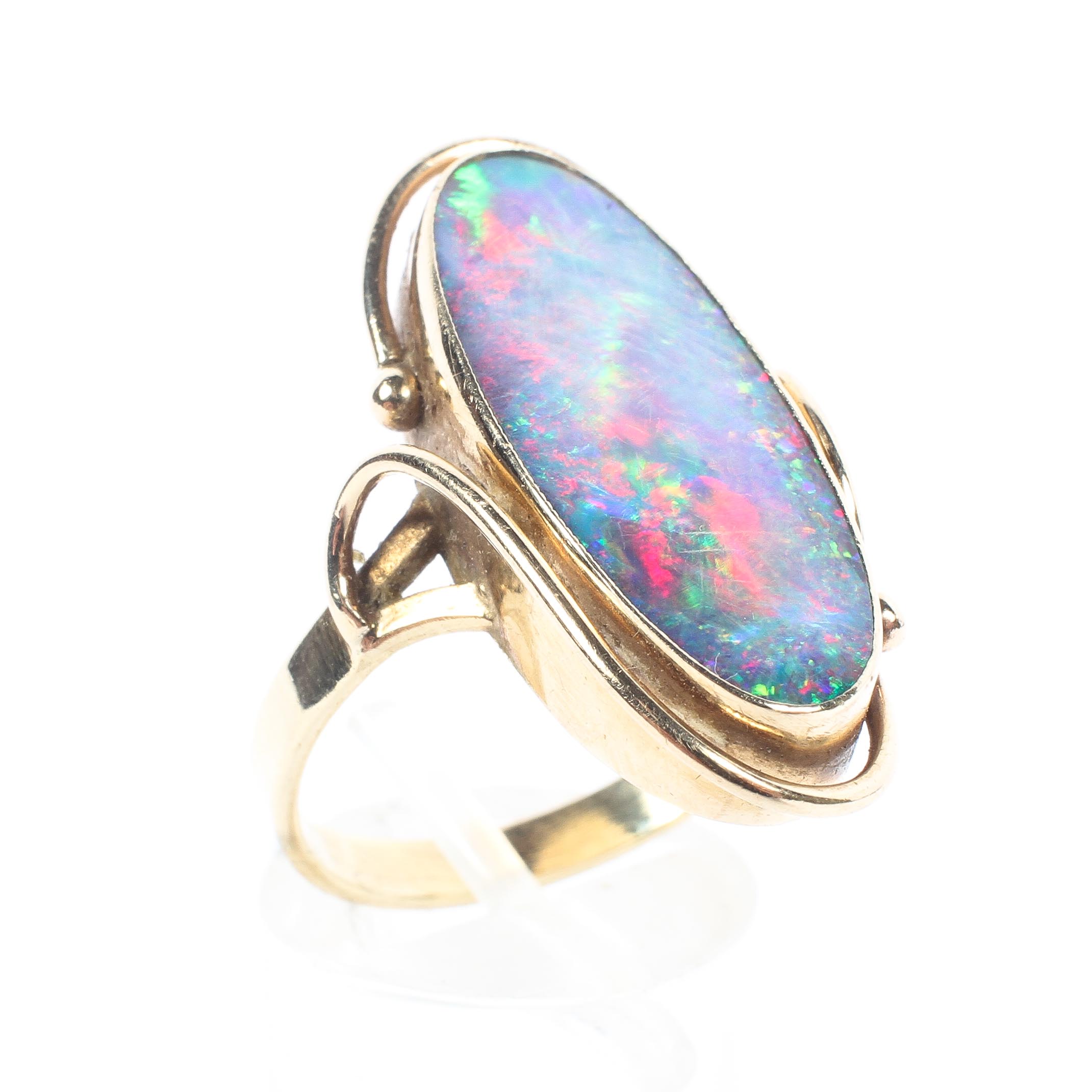 A 15ct gold black opal dress ring, oval black opal triplet in bezel setting. 5.8g Size S.