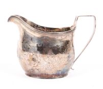 A sterling silver Georgian cream jug with scrolling chased decoration by Peter & William Bateman,