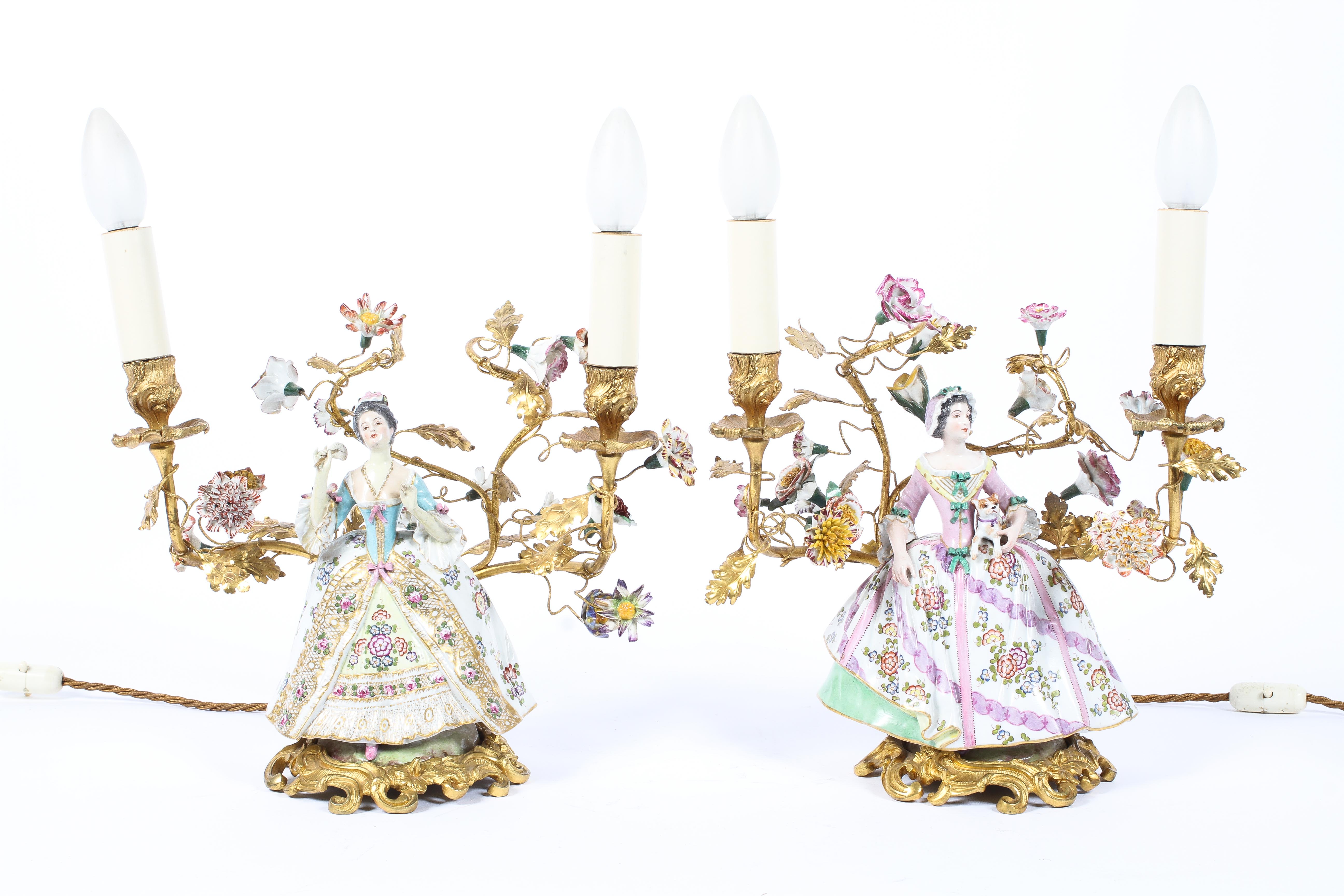 A pair of gilt metal and Continental porcelain twin-light candelabra,