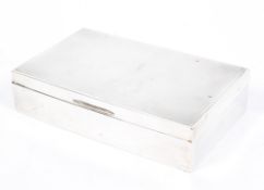 A George V silver cigarette box of rectangular form, the lid with engine turned decoration,