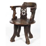 An oak corner chair, having a foliate carved bow crest rail,