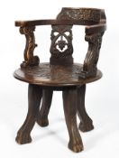 An oak corner chair, having a foliate carved bow crest rail,