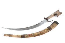 A Middle Eastern dagger, inlaid with white metal and red/orange enamel or stone,