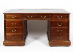 An Edwardian pedestal desk with leather inset top on plinth base, 148cm x 80cm x 75cm.