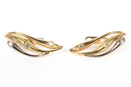 A pair of 18ct gold and diamond set clip earrings. 5.9g.