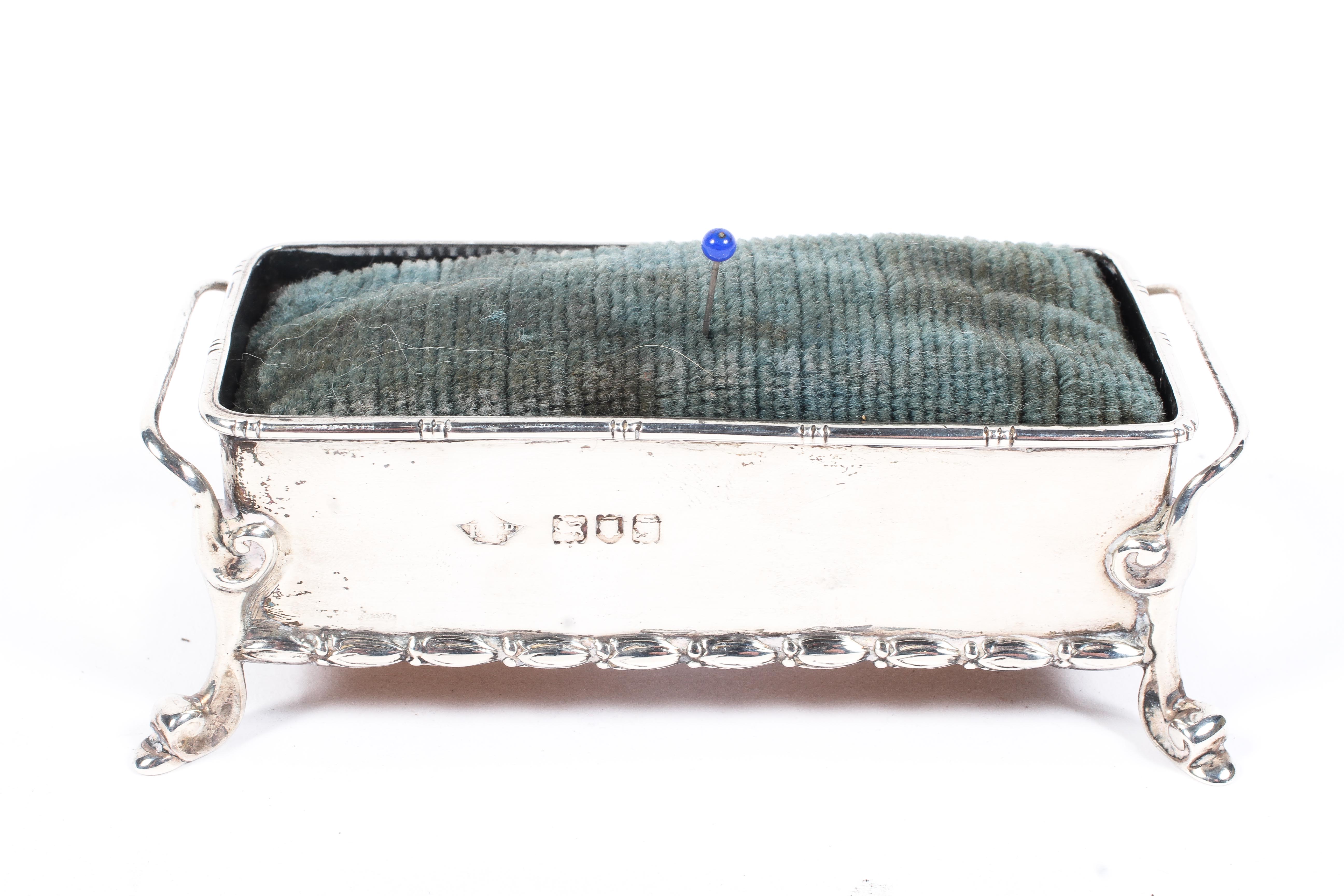 An Edwardian silver pin cushion of rectangular form, twin handled and raised upon scrolling feet, - Image 2 of 2