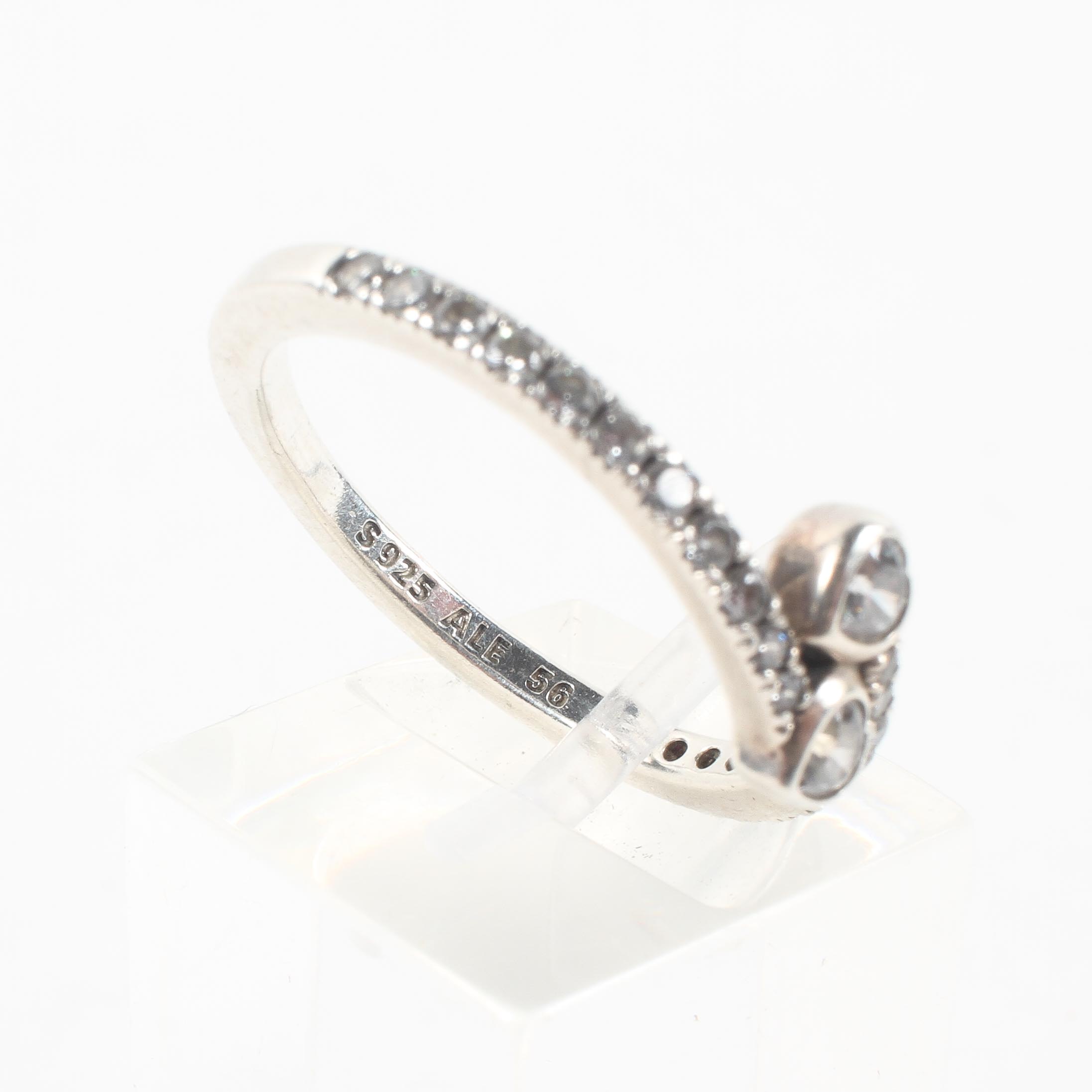 A sterling silver crossover ring set with heart and round cut colourless cubic zirconia. - Image 4 of 4