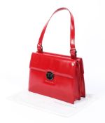 A Tanner Krolle (London) red leather handbag, bearing red leather label to interior pocket,