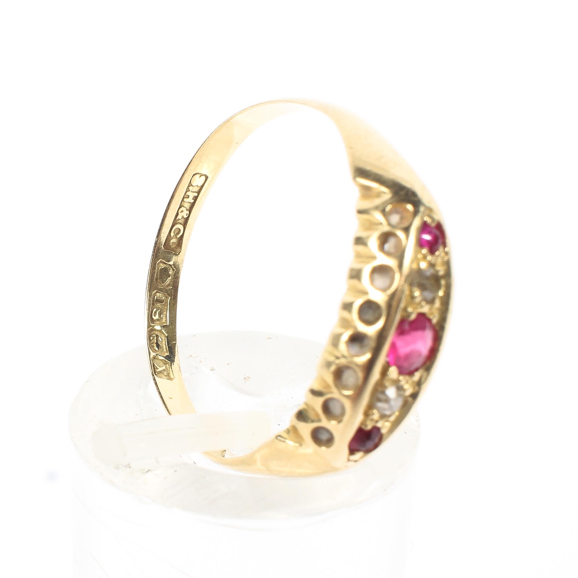 An 18ct gold ruby and diamond ring. Three round cut rubies with single cut diamond accents. 2.0g. - Image 4 of 4