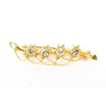 An unmarked yellow metal diamond set bar brooch. 2.6g.