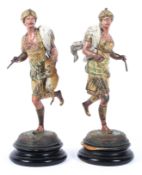 Two arabesque style painted and gilt spelter figures of a hunter and huntress
