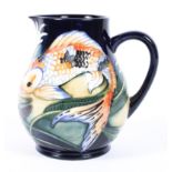 A contemporary Moorcroft 'Koi' pattern jug, by Philip Green, stamped and dated 2002,