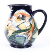 A contemporary Moorcroft 'Koi' pattern jug, by Philip Green, stamped and dated 2002,