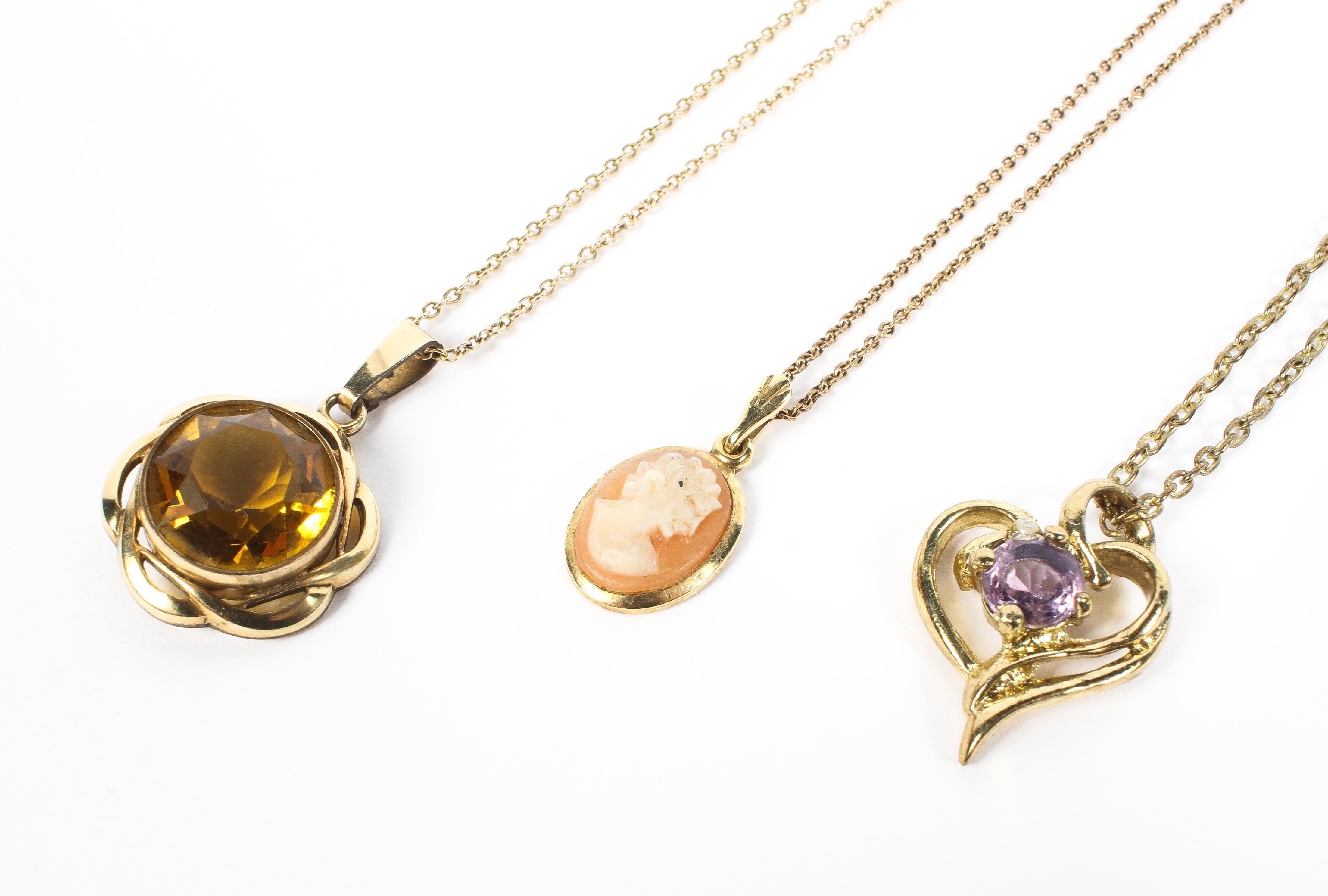 Three unmarked yellow metal gem set pendants on yellow metal chains. 10.7g. - Image 2 of 2