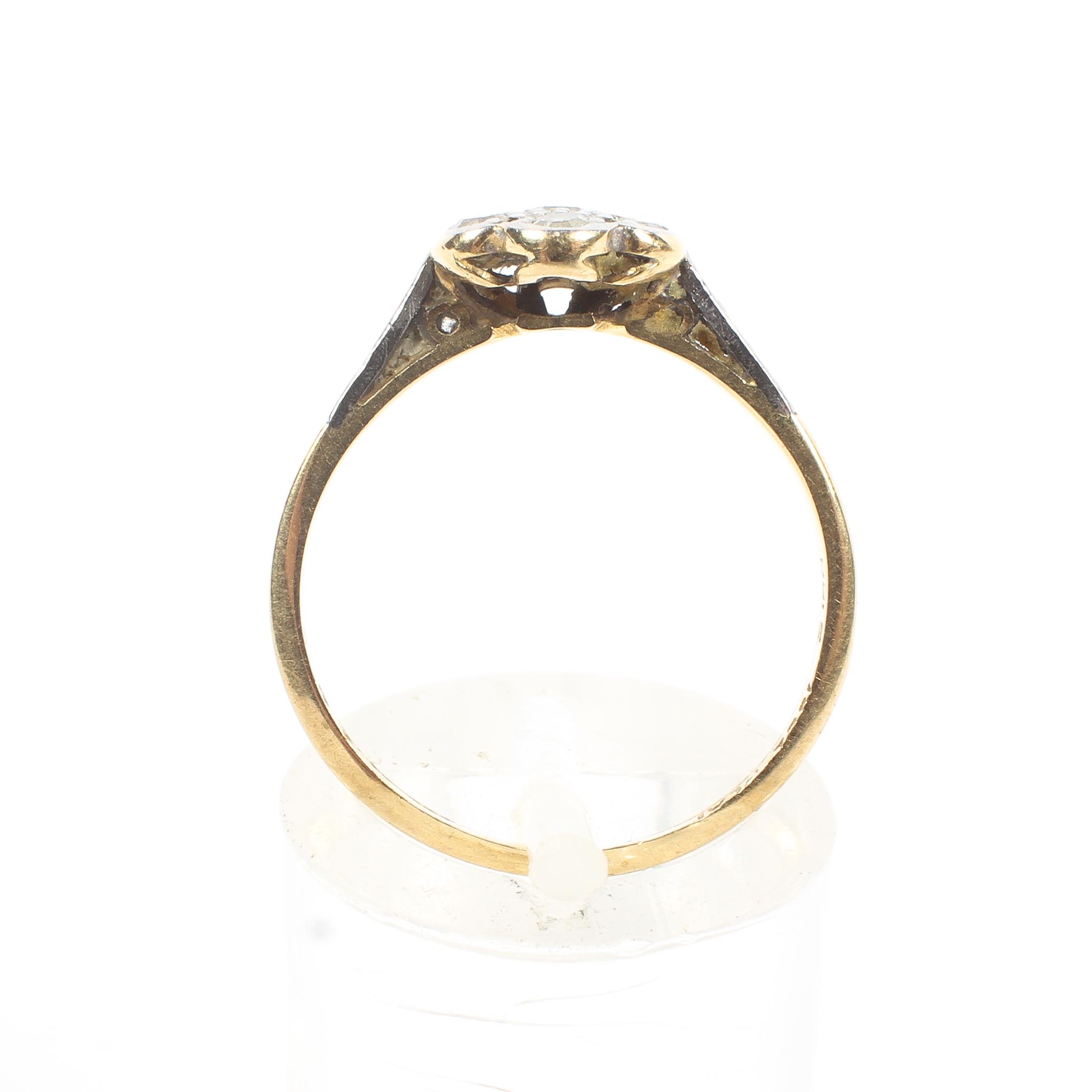 An 18ct gold and platinum flower ring. Set with seven single cut diamonds. 2.1g. Size M. - Image 3 of 4