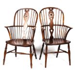 A pair of 19th Century oak wheelback Windsor elbow chairs,