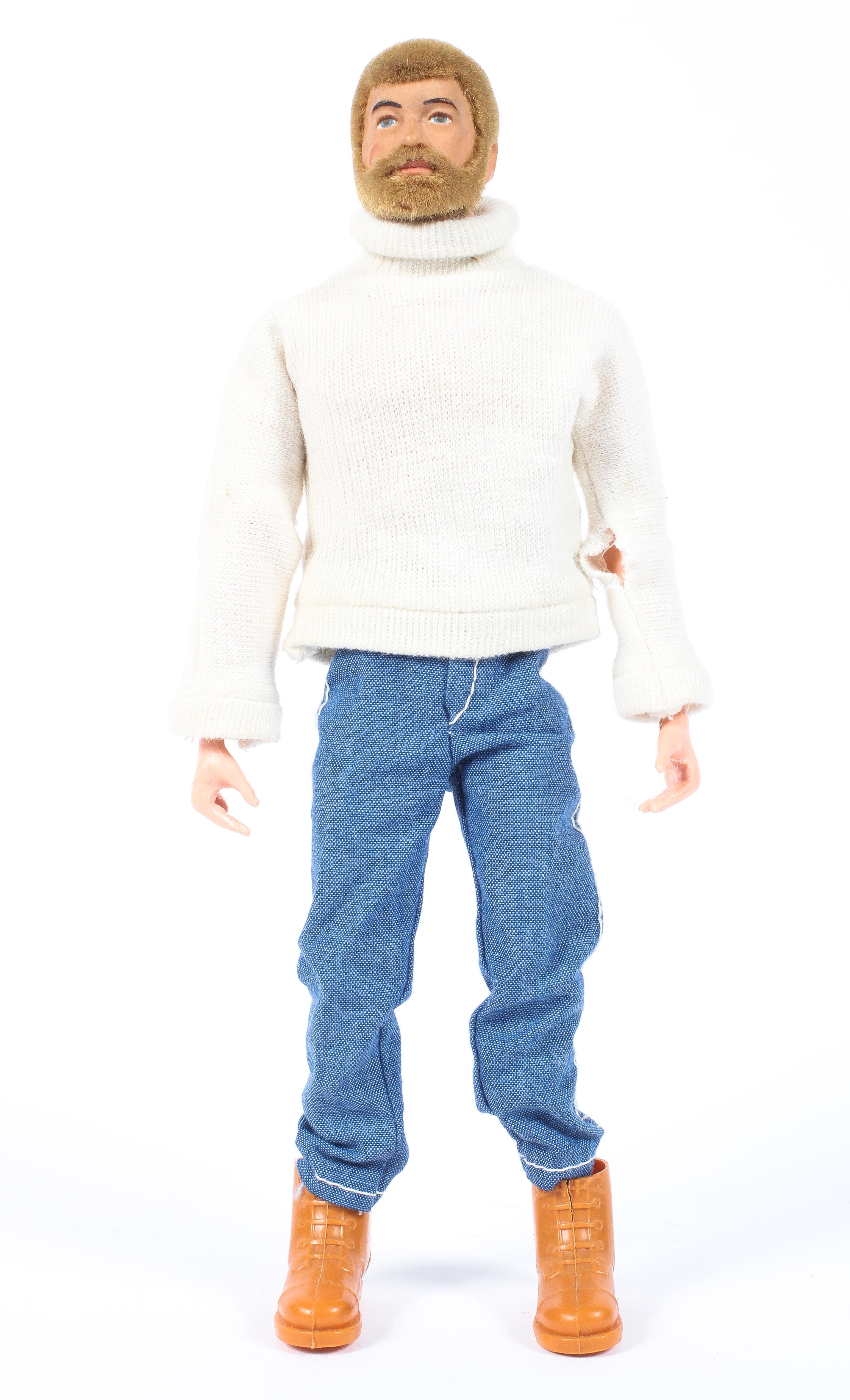 A vintage Action Man with blond hair and beard, in a roll neck sweater, jeans and boots,