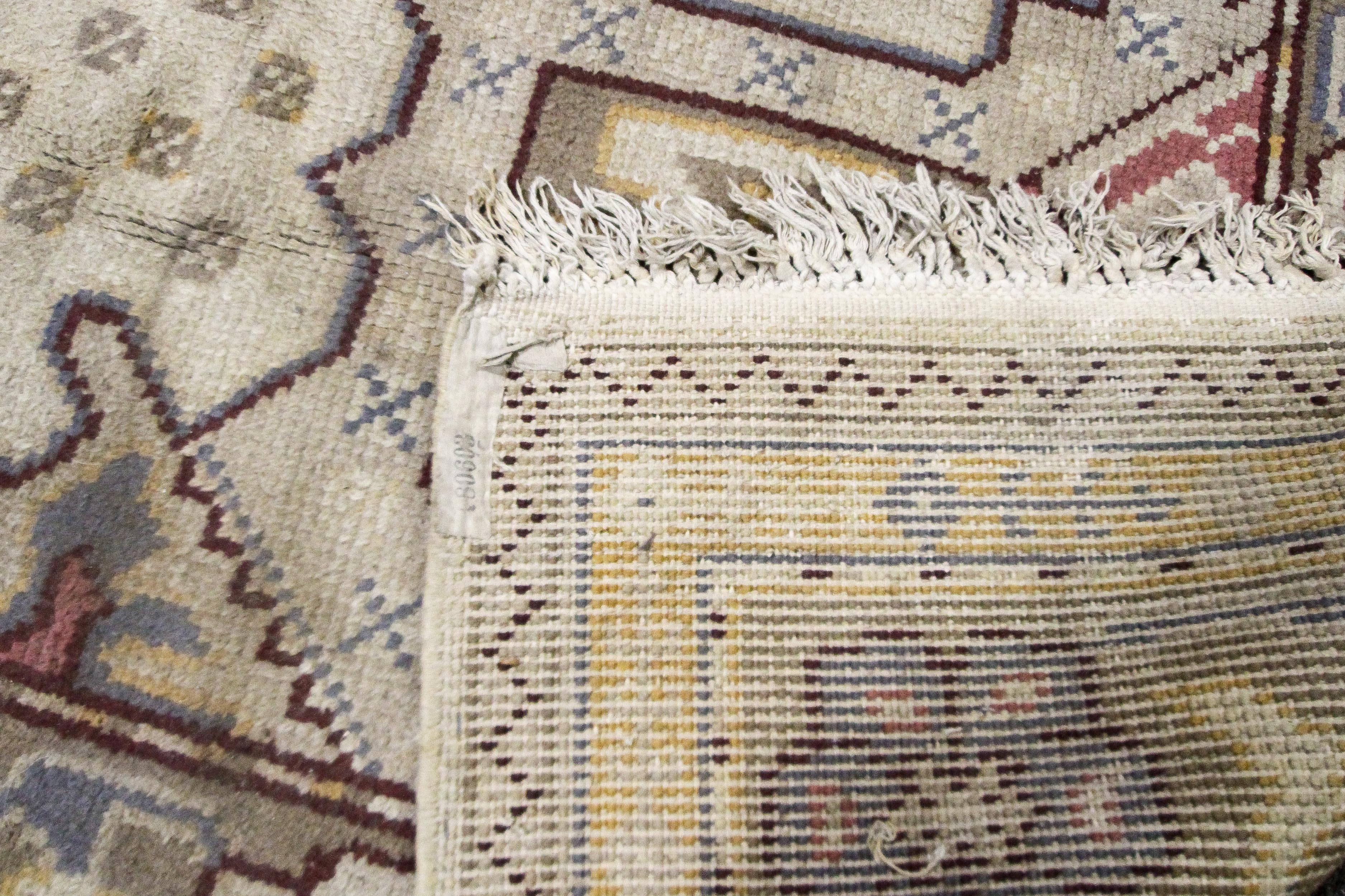 An Oriental style wool rug, cream ground with central geometric medallion, - Image 3 of 3