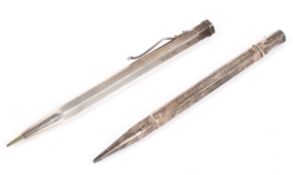 Two mid century silver pencils, both with engine turned decoration to their cases,