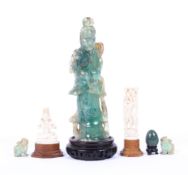 A Chinese carved green quartz figure together with others