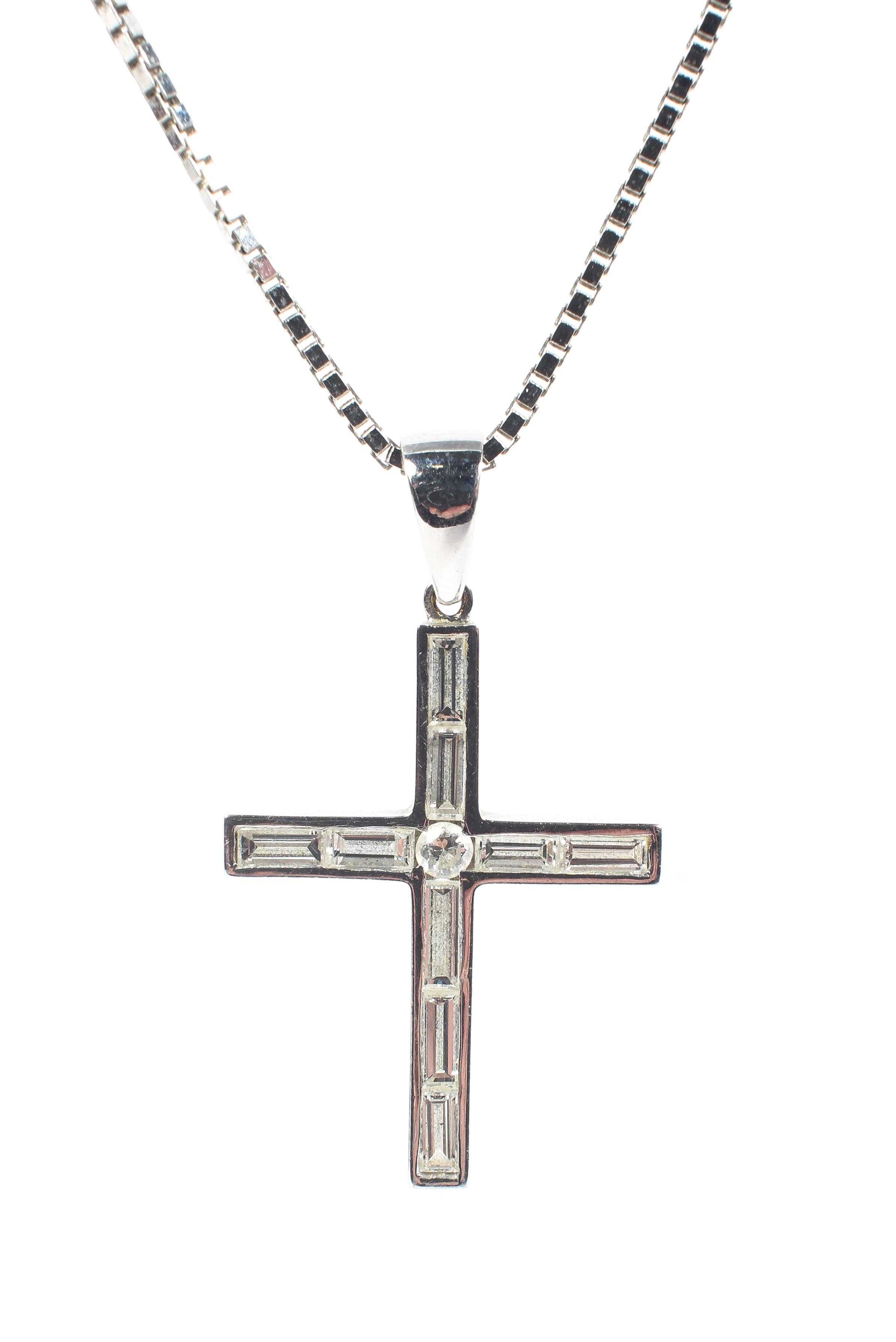 An 18ct white gold diamond set crucifix on 18ct gold box link necklace,