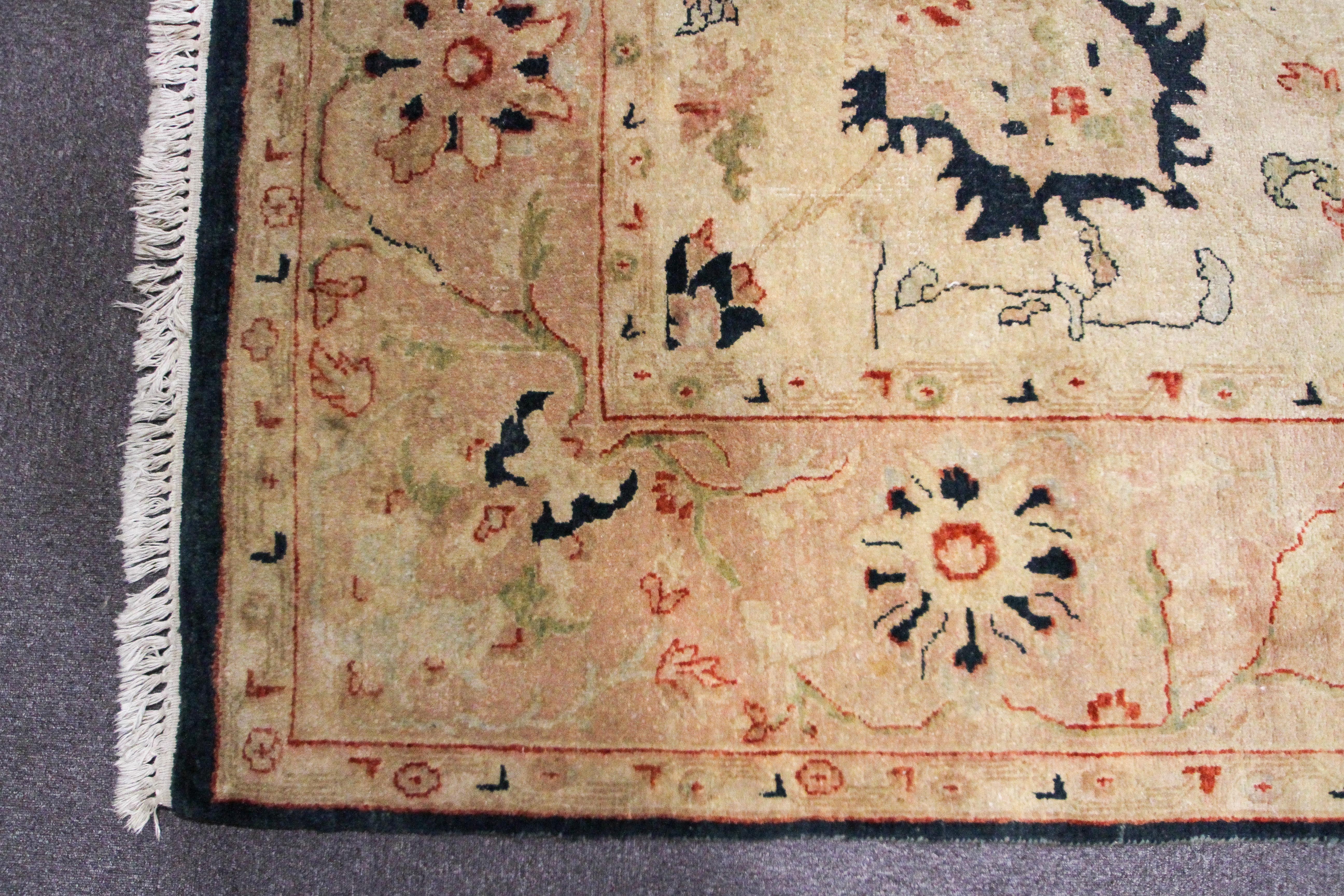 A Persian style large wool rug, woven with floral motifs on a buff/yellow ground, - Image 2 of 3