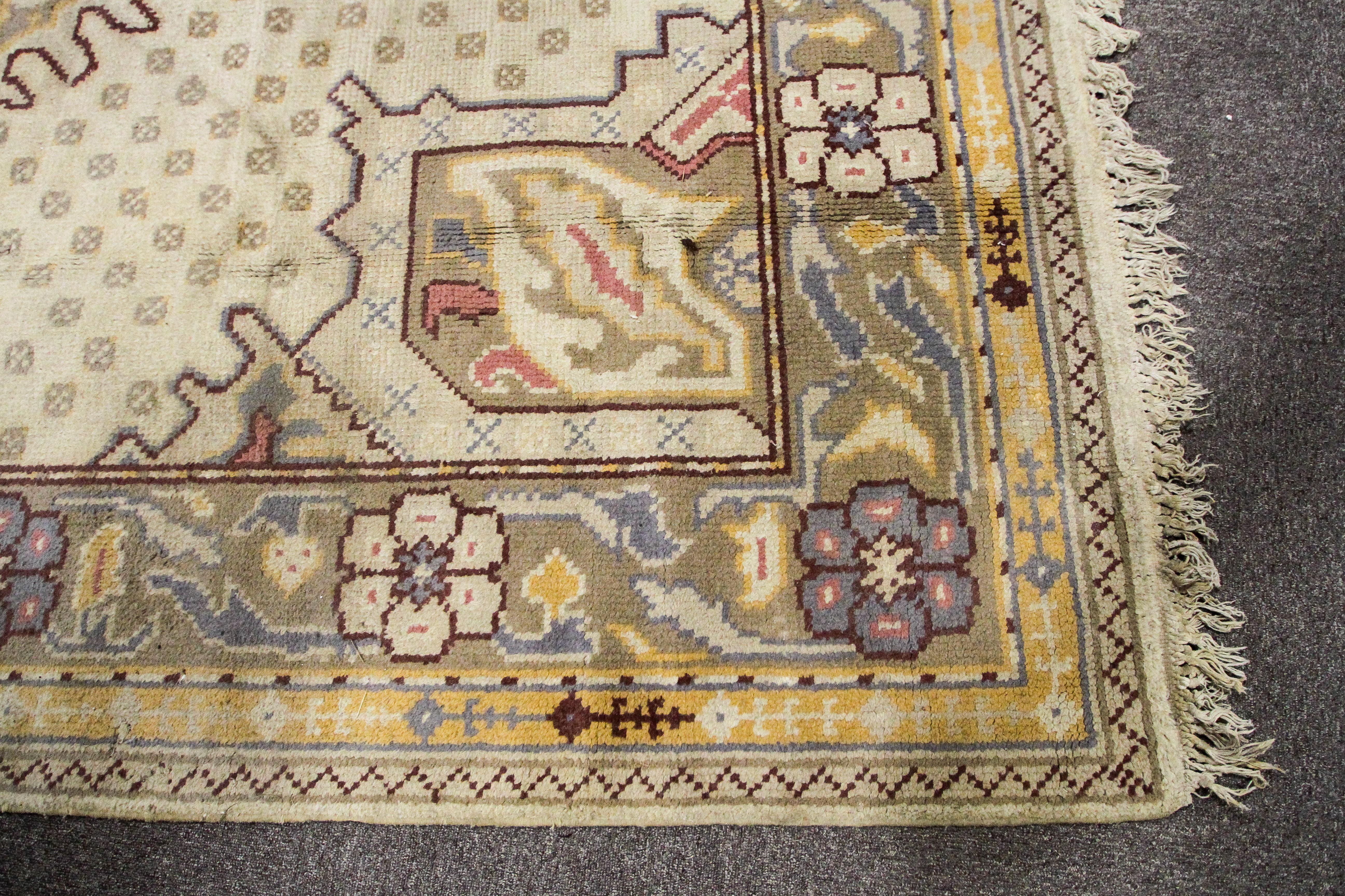 An Oriental style wool rug, cream ground with central geometric medallion, - Image 2 of 3