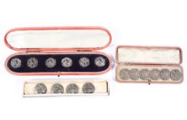 Two boxed sets of six white metal buttons together with a set of four German white metal buttons.