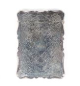 A Continental silver card case of rectangular form, adorned with flowing engraved foliate motifs,