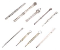 A collection of nine late 19th/early 20th century silver and unmarked white metal propelling pencils
