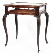 A Late Victorian mahogany bijouterie table, of serpentine outline,