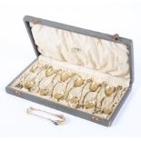 A boxed set of 12 gilt metal and silver stamped coffee spoons and a pair of tongs