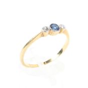 An 18ct gold sapphire and diamond ring, central round cut sapphire with single cut diamond accents.