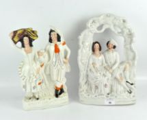 Two Staffordshire flatbacks, one of a standing couple with a vase,