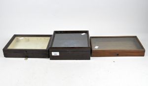Three Victorian wooden mahogany boxes, with hinged lids and glass panels to the front.