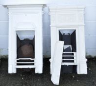 Two late 19th/early 20th century cast metal fire places, with moulded decoration, painted white,