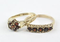 Two 9ct gold ladies rings, one set with five red stones, the other a daisy cluster,