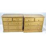 A pair of pine side cabinets, two short drawers above two long ones, all with turned handles,