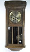 A 20th century wall clock, brass dial with Arabic numerals,
