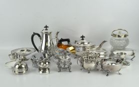 A group of silver plated wares, including an ornate sugar scuttle, three piece tea set,