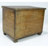 An antique pine blanket box, with hinged top, raised on square tapered legs,