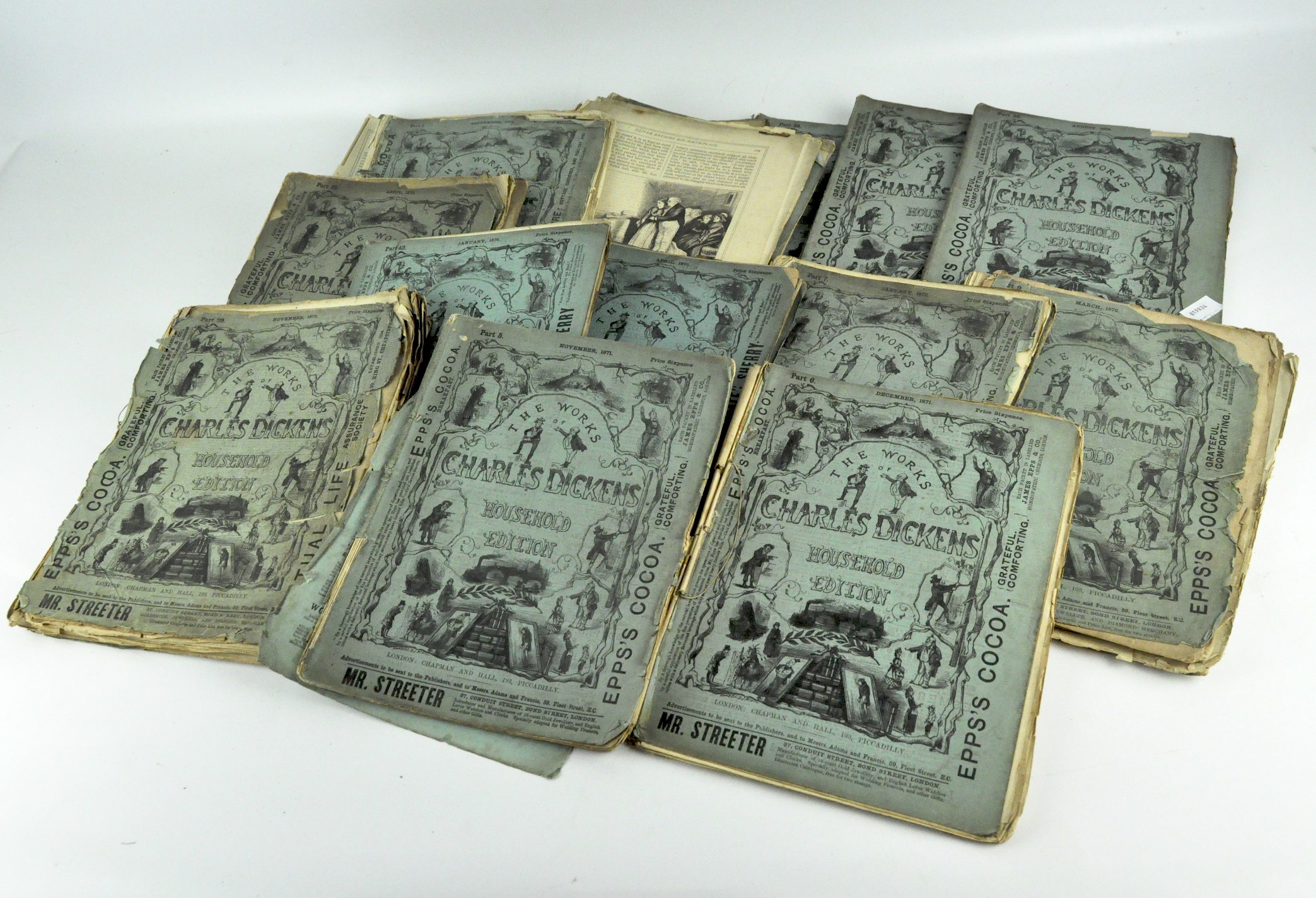 A collection of various monthly editions from 1871-1875 of 'The Works of Charles Dickens',