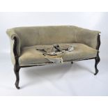 A Victorian two seater sofa, wooden frame with cabriole supports and ribbed fabric upholstery,