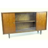 A mid-century shallow sideboard with one shelf each behind two solid and one glass sliding door,