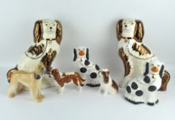 A collection of contemporary ceramic dogs including two pairs of King Charles spaniels,