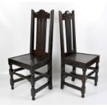 A pair of 19th century oak hall chairs, with partially panelled backs and turned supports,