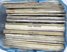 A collection of vinyl records, including works by Jim Reeves,