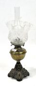 A Victorian brass oil lamp together with a fluted edge pattenated glass shade